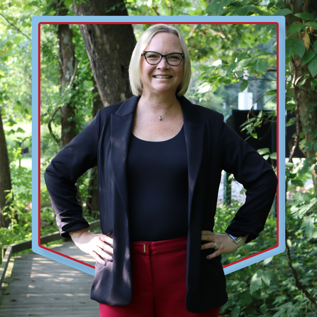 Joanne Gillespie poses in front of wooded background.